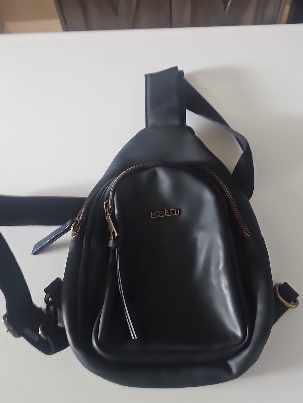 Rosetti Black Faux-Leather Sling Bag with Gold Hardware